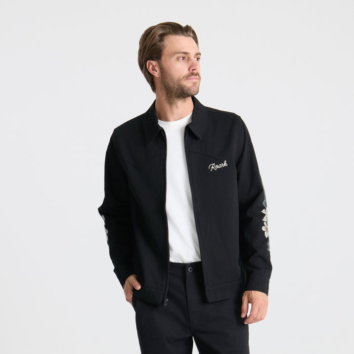 Versatile long-sleeved black active shirt by Roark featuring a zippered collar, designed for adventure and outdoor activities.