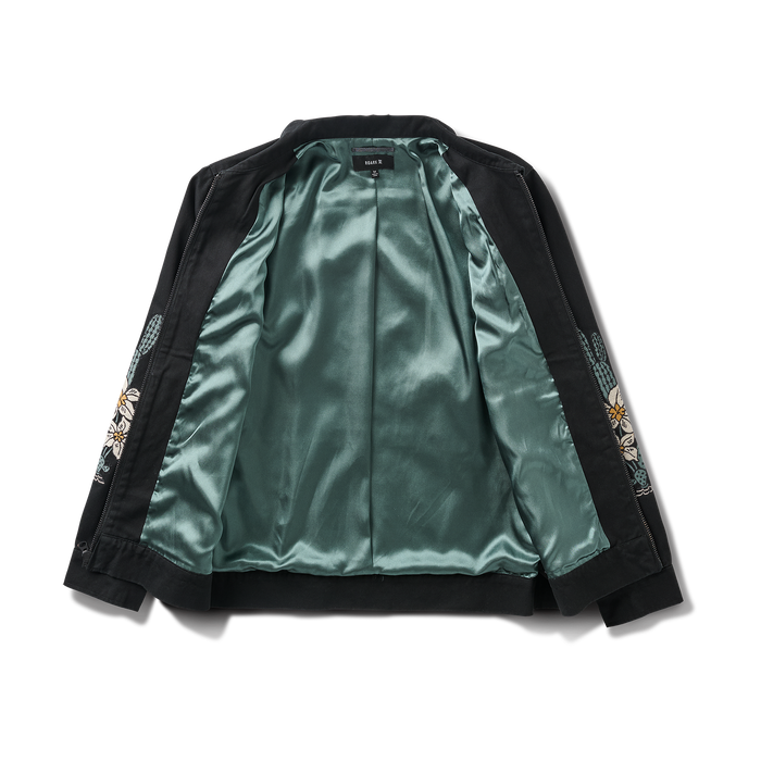 Close-up of a stylish black leather jacket featuring detailed stitching on the sleeve and a rugged collar, embodying Roark's adventure-ready fashion aesthetic.