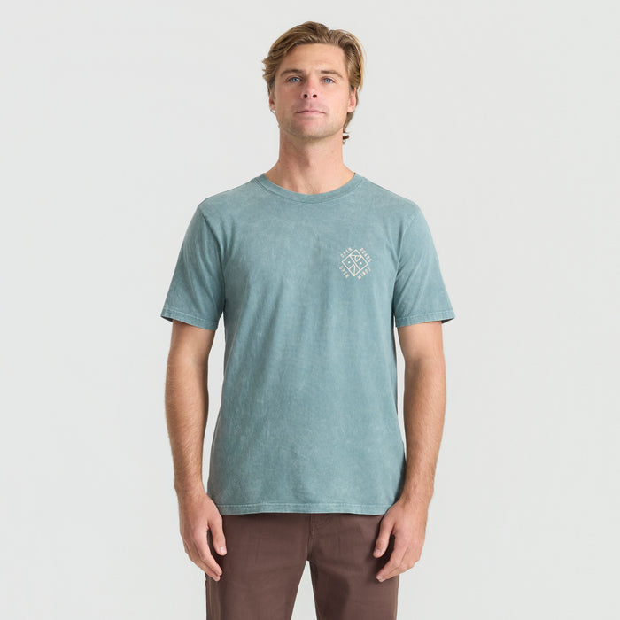 Man wearing a rugged denim active shirt by Roark, ideal for adventure and outdoor activities.
