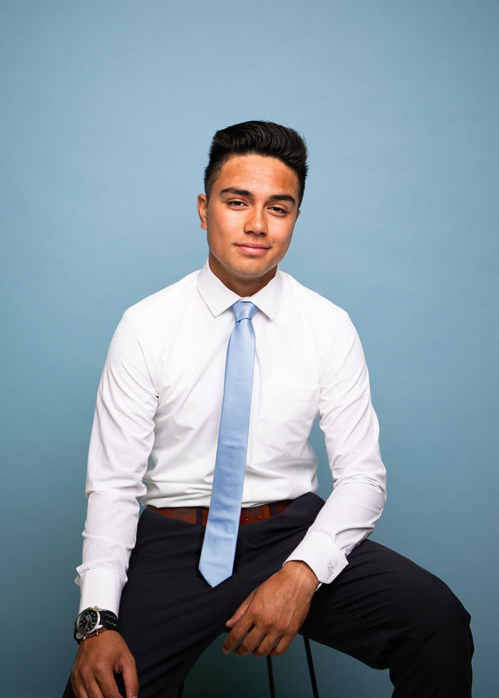 Solid light blue tie on a white shirt