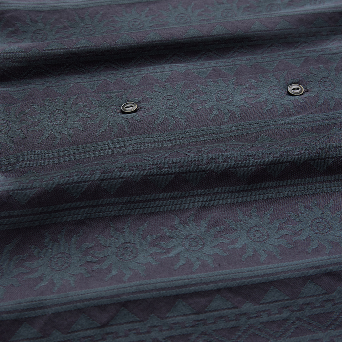 Ebony Gonzo short sleeve button up shirt detail showing dark patterned fabric with metal eyelets and textured weave