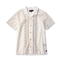 Cream short sleeve button-up shirt with tan embroidered geometric pattern down the front and white collar