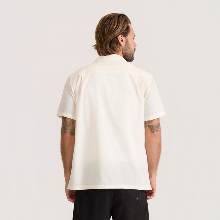 Roark Gonzo unbleached short sleeve button up shirt on male model shown from behind, paired with black shorts