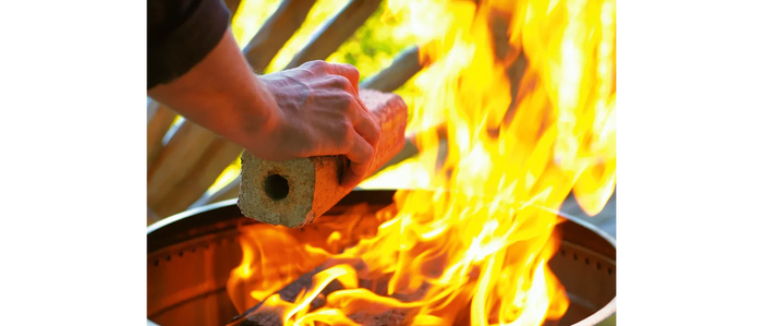 Brown Compressed Firewood Log Being Added to Fire - Action Shot | United RV Parts