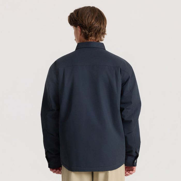 Hebrides 10k Jacket in deep navy worn by model from back, showing collar and long sleeves against neutral background