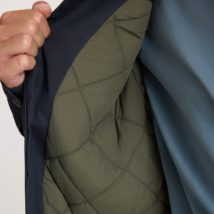 Hebrides 10k Jacket in deep navy with olive quilted lining visible, worn open to show interior detail