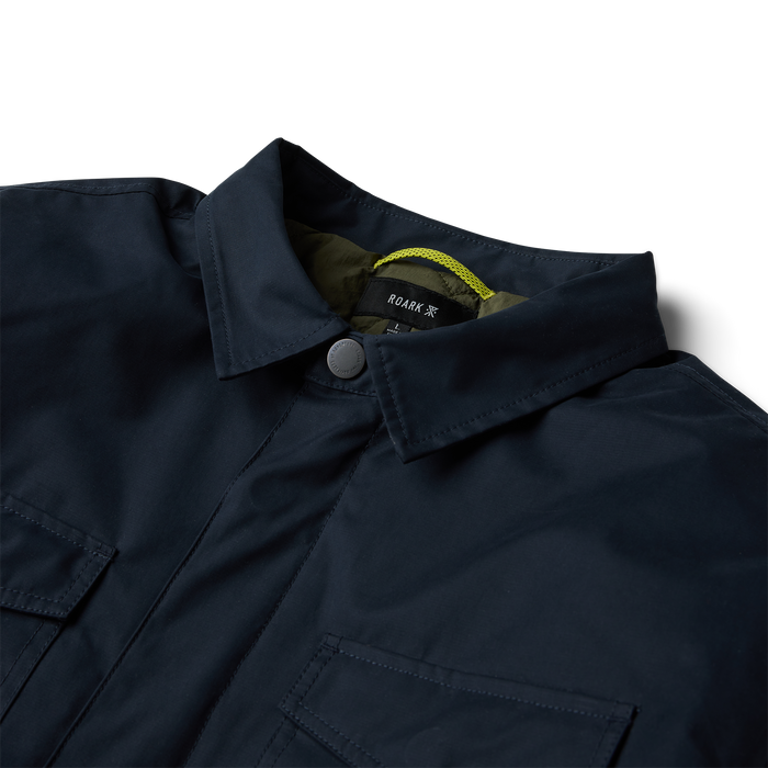 Roark Hebrides 10k Jacket in deep navy with olive lining and yellow drawstring visible at open collar, detail shot