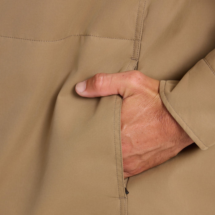 Hebrides 10k jacket in khaki with hand in pocket, showing quilted seams and durable fabric construction detail