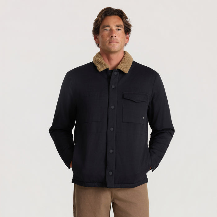 Black Hebrides 2.0 Sherpa Jacket with tan fleece collar, worn by model with hands in pockets, front view