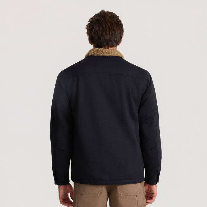 Hebrides 2.0 Sherpa Jacket in black with tan fleece collar, shown from back on male model wearing khaki pants