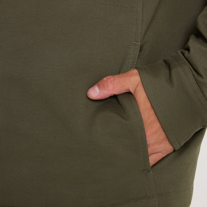 Olive green Hebrides 2.0 Sherpa Jacket with hand in front pocket, showing garment detail and fabric texture on model