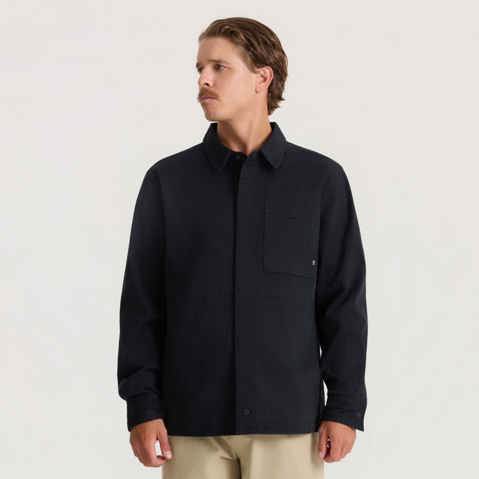 Black Hebrides 2.0 unlined jacket with collared neckline and chest pocket, worn by man against neutral background