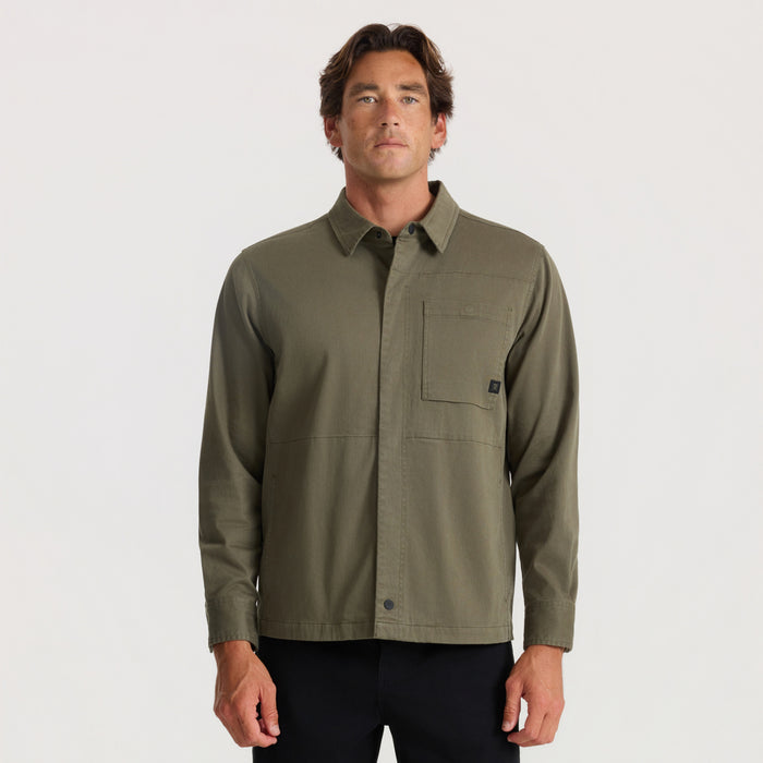 Hebrides 2.0 unlined jacket in military green worn by male model with collared front pocket detail on neutral background