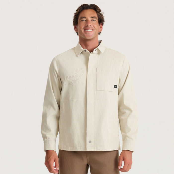 Hebrides 2.0 Unlined Jacket in sand worn by man with collared neckline and chest pocket detail on neutral background