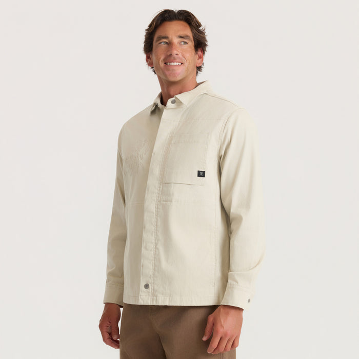 Hebrides 2.0 Unlined Jacket in sand worn by man with brown pants, angled three-quarter view against neutral background