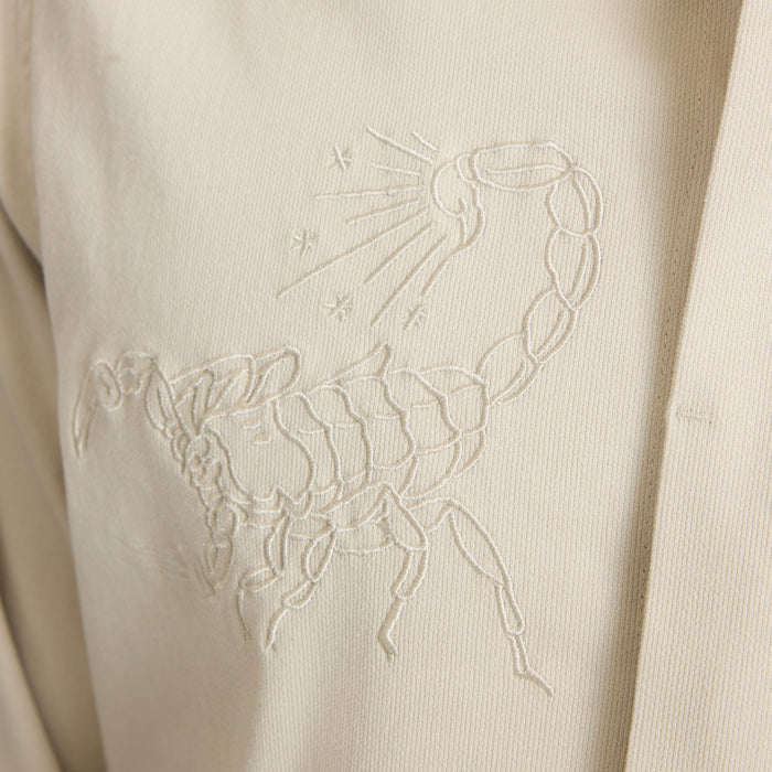 Hebrides 2.0 unlined jacket in sand with embroidered scorpion design detail on chest pocket area