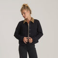 Black Hebrides Sherpa Jacket with tan fleece collar worn by model, button front and chest pocket visible