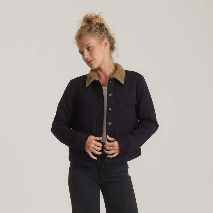 Black Hebrides Sherpa Jacket with tan fleece collar worn by model, button front and chest pocket visible
