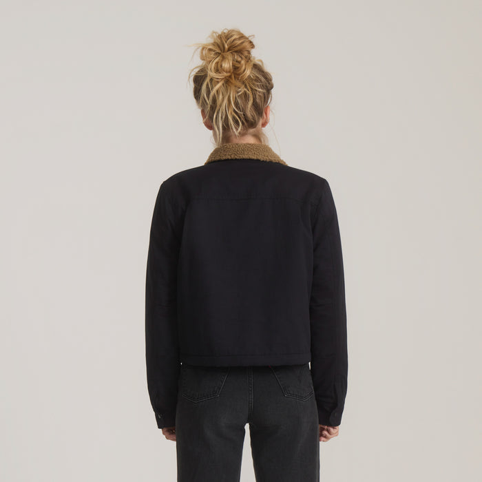 Black Hebrides Sherpa jacket with tan sherpa collar shown from back on model wearing dark jeans
