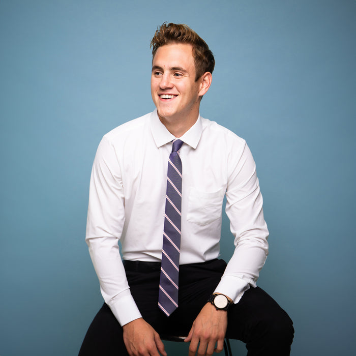 Blue tie with red and white stripes on a white shirt