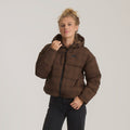 Brown quilted Hokkaido 2.0 jacket with hood worn by model with black jeans against neutral background
