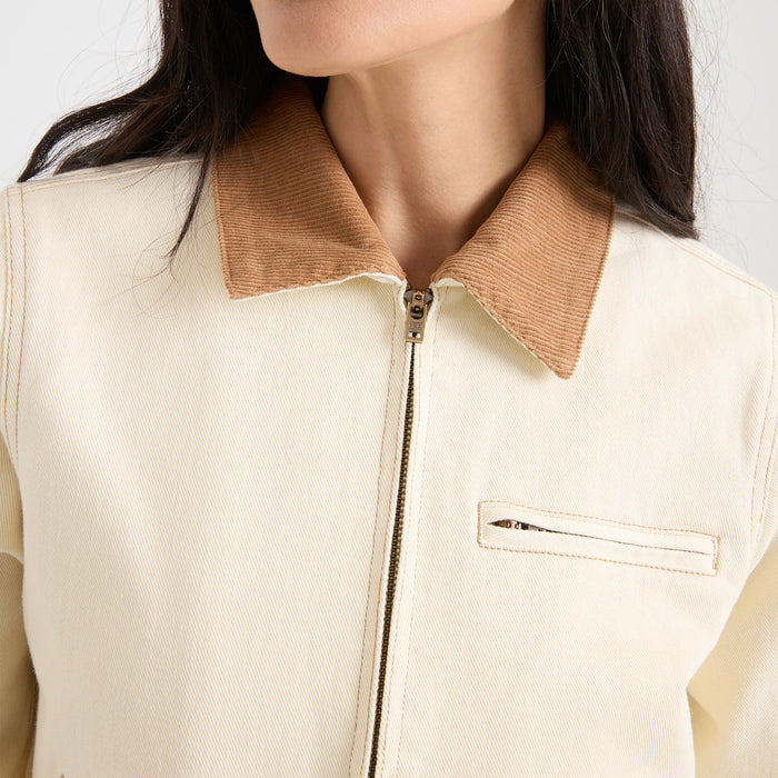 Model showcasing a rugged Roark outdoor button-up shirt, detailed with natural material and a prominent collar, ideal for adventure and travel.