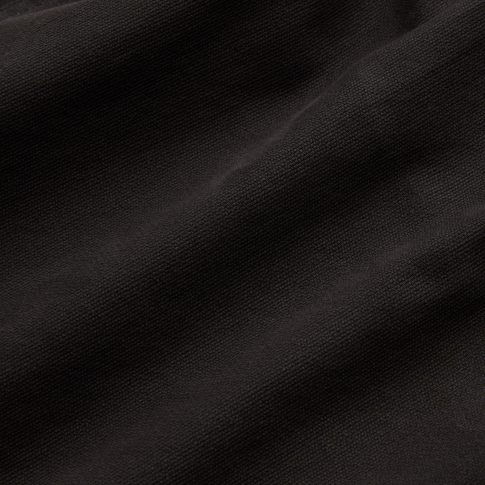 Close-up of a woven grey textile, highlighting the texture and quality, perfect for Roark's adventure-inspired apparel.