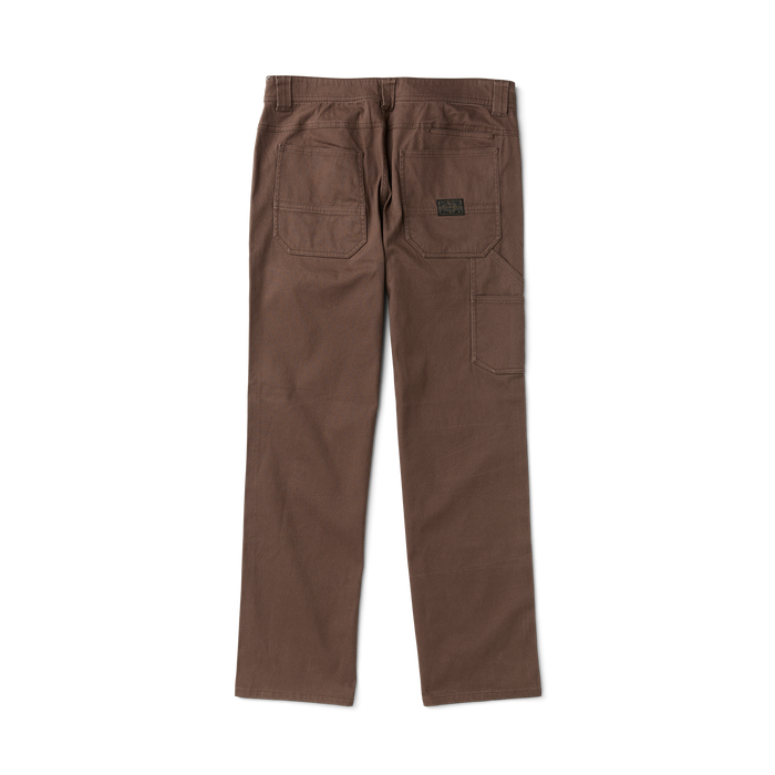 Close-up of khaki adventure pants featuring a detailed brown label and practical pockets, perfect for travel and outdoor activities.