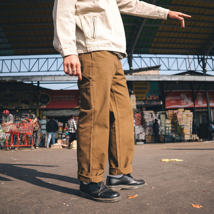 Roark-inspired rugged denim on scenic Highway 1 near railroad tracks, evoking a sense of adventure and exploration.