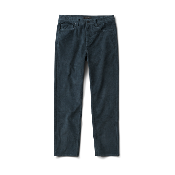 Close-up of rugged denim jeans featuring a detailed pocket, button, and label design, ideal for adventure and outdoor travel by Roark.
