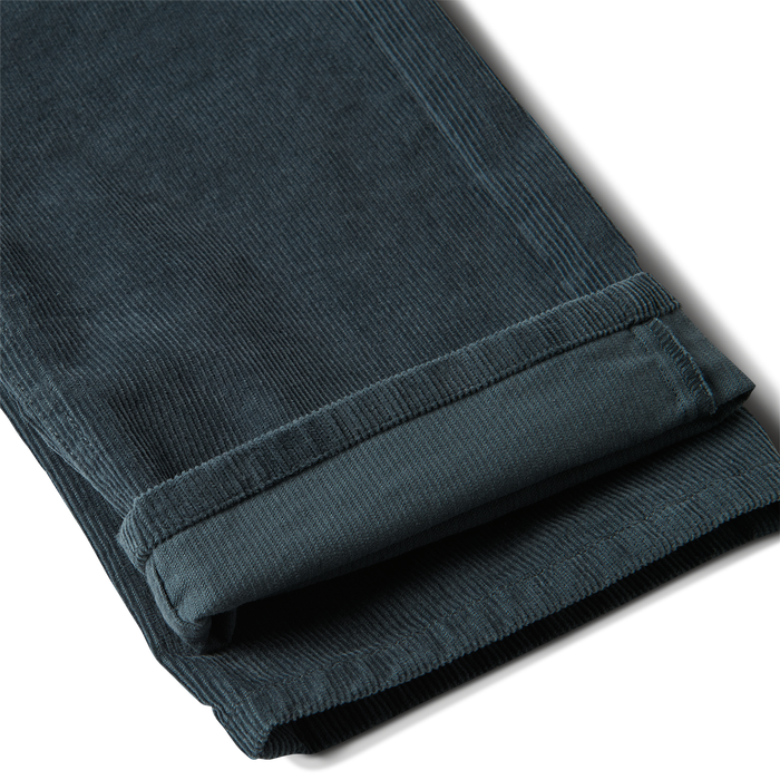 Close-up of textured denim active pants featuring detailed design with visible pockets and buttons, perfect for outdoor adventures and travel