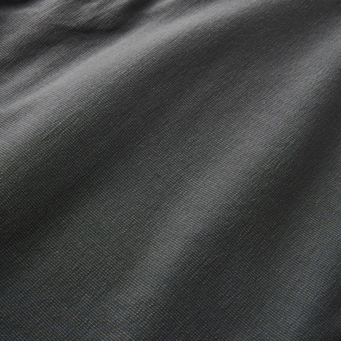 Close-up of intricate grey and silver woven fabric texture, ideal for stylish and durable outdoor apparel by Roark.