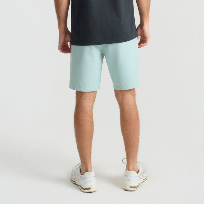 Adventurous young calf exploring sandy beach while wearing Bermuda shorts and trunks, embodying the spirit of outdoor exploration and travel.