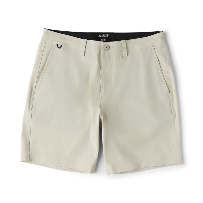 Roark Hytide Hybrid Shorts in sand flat lay showing front pockets, button closure, and black waistband label