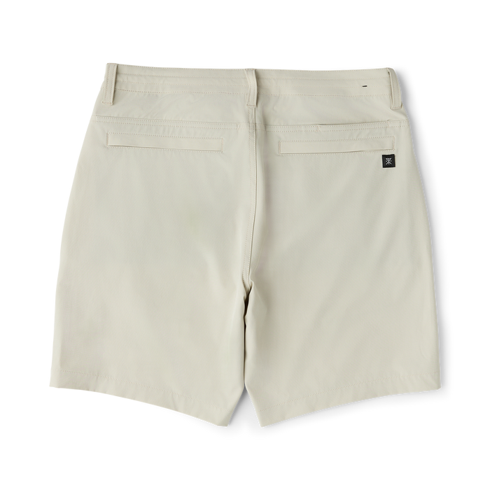 Cream-colored Hytide Hybrid Shorts displayed flat lay, showing back pockets and branded label on right rear pocket