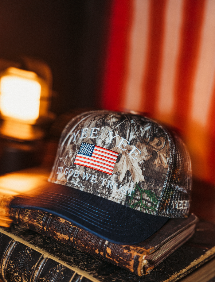 Camouflage cap with American flag design on a book with a blurred background