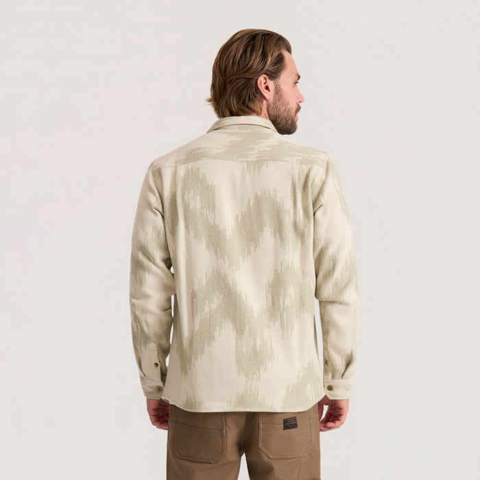 Man wearing oat-colored Journey Jacquard long sleeve flannel with subtle geometric pattern, shown from back view against neutral background