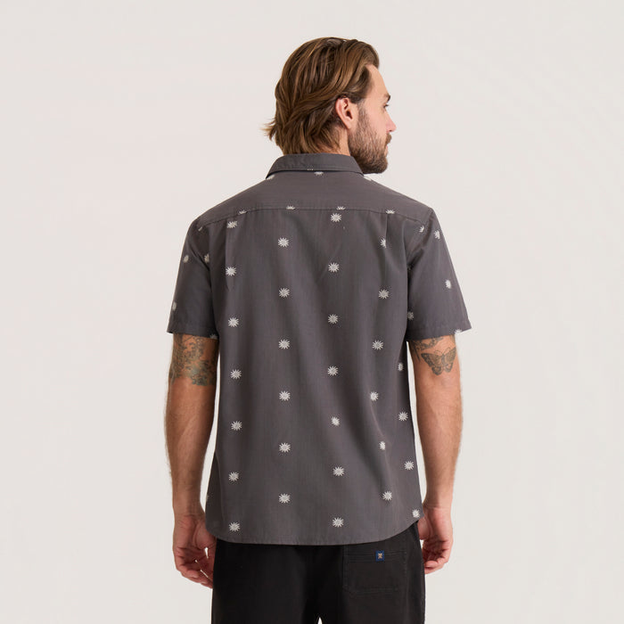 Charcoal short sleeve button up shirt with white sun print, worn by man shown from back view
