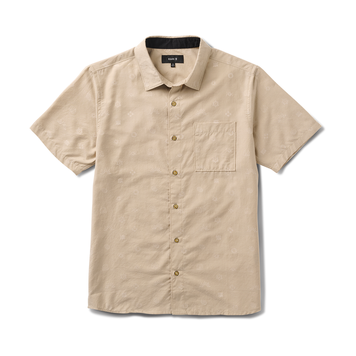 Detail of a stylish Roark dress shirt featuring a classic collar, buttons, and intricate fashion design, perfect for adventure and travel.