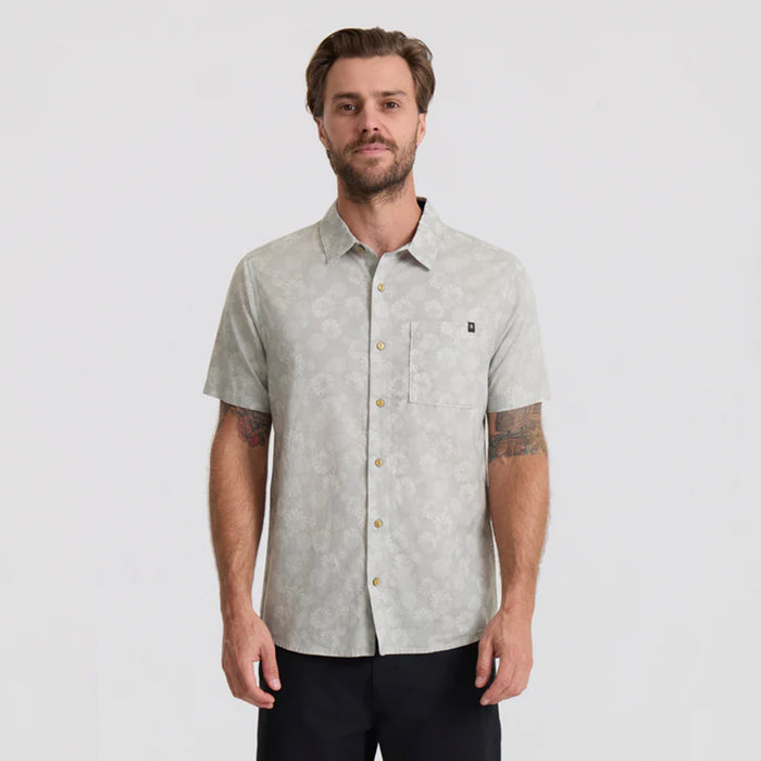 Close-up of a versatile Roark dress shirt featuring detailed stitching on the collar, buttons, and sleeve, ideal for travel and outdoor adventures.