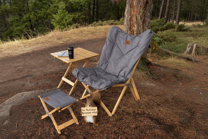 Kuma Yoho Bamboo Stool Used as Footrest with Butterfly Chair and Side Table - Campsite Lifestyle | United RV Parts