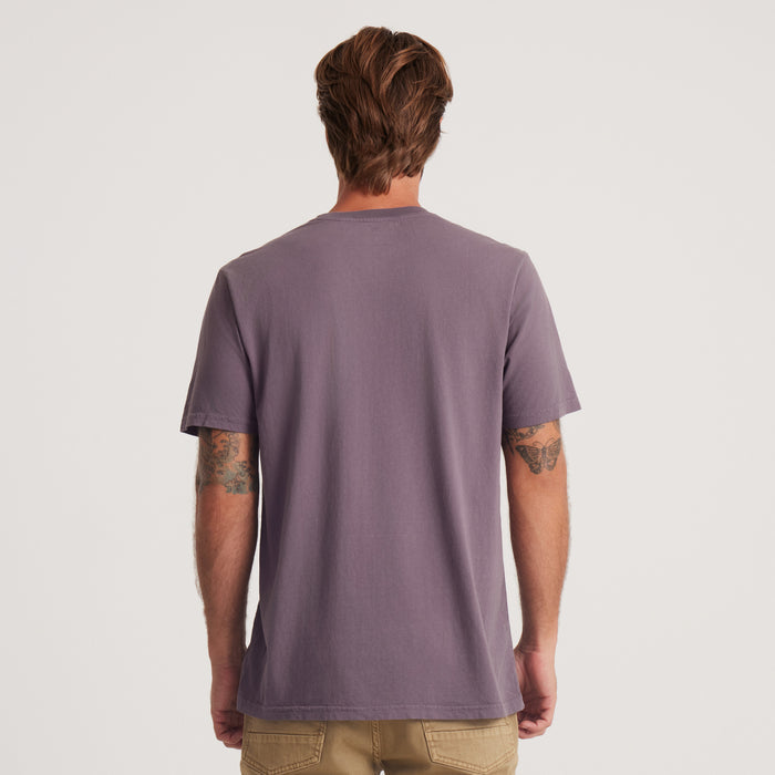 The back view of a Roark short-sleeve t-shirt showcases a minimalist design in muted purple, perfect for effortless style on the go.