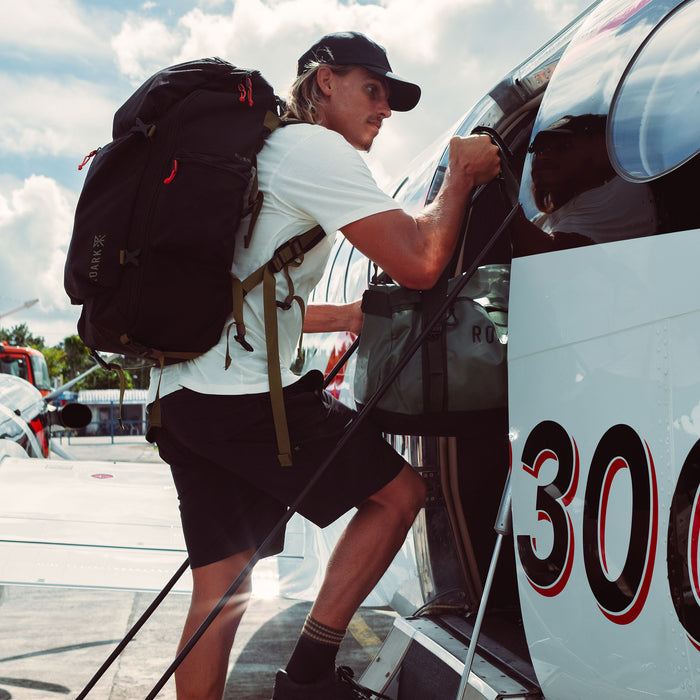Koa Smith boards a plane in the Layover Pro Shorts.