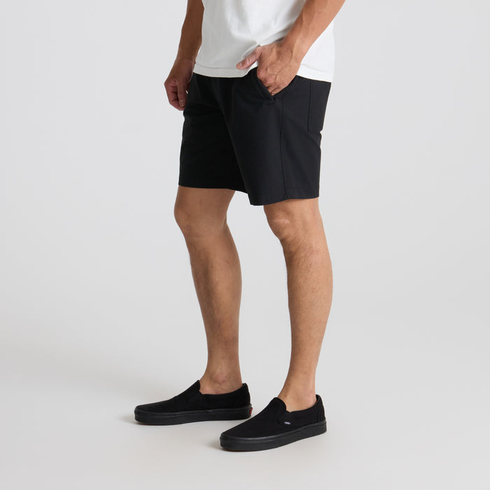 Black adventure shorts designed for outdoor activities, showcasing a fit that extends to the knee, ideal for travel and exploration.
