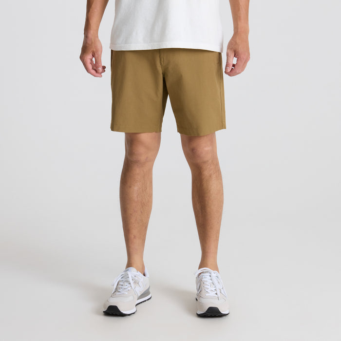 Man wearing Roark's active Bermuda shorts while exploring outdoors, showcasing the calf-length cut ideal for adventure travel.