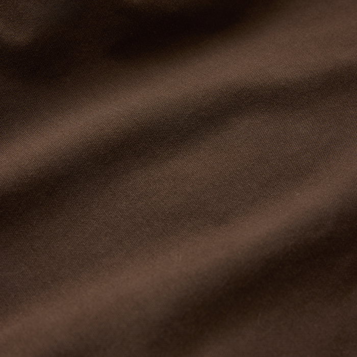 Layover Pro Traveler Shorts in tobacco brown showing woven fabric texture and drape detail
