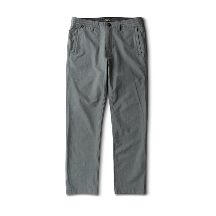 Man wearing Roark outdoor adventure apparel while exploring a rugged landscape.
