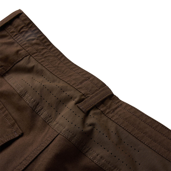 Layover Pro Traveler Pants in tobacco brown showing detail of waistband with perforated breathable panel and cargo pocket stitching