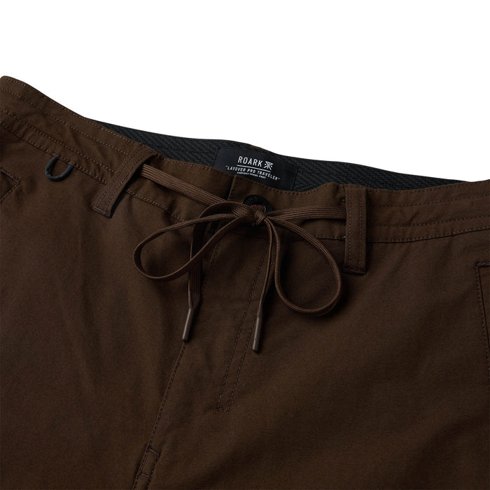 Layover Pro Traveler Pants in tobacco brown with drawstring waistband and dark interior lining, flat lay detail shot