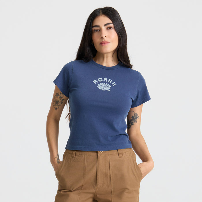 Close-up of a textured active Muse tee shirt highlighting the detailed stitching on the sleeve and shoulder, perfect for outdoor adventures and travel.